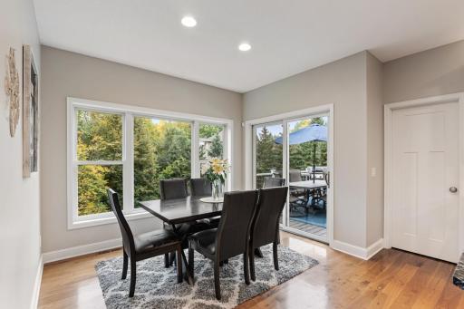 Informal dining area with a sliding door to the deck; adjacent door leads into the walk-in pantry.