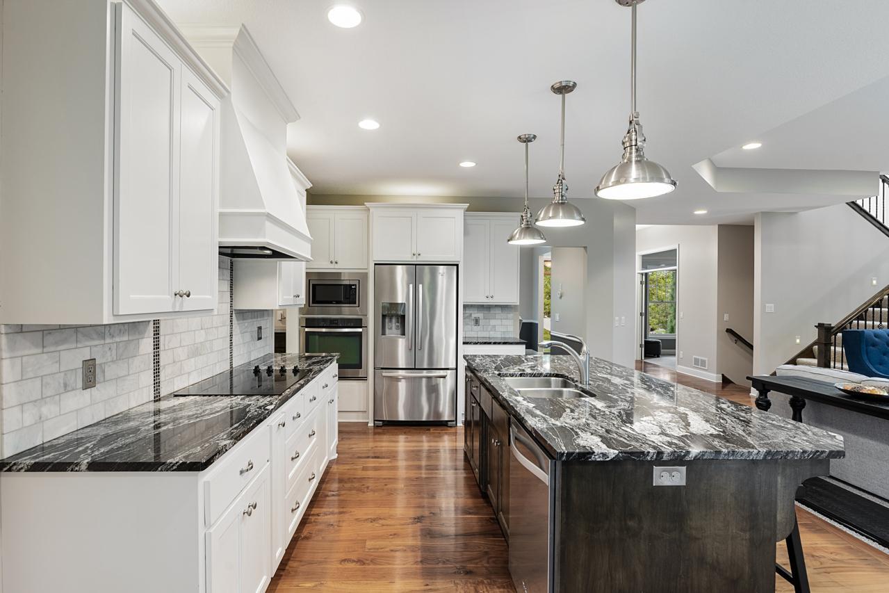 Stainless steel appliances complement this light, open kitchen with a fresh, modern feel.