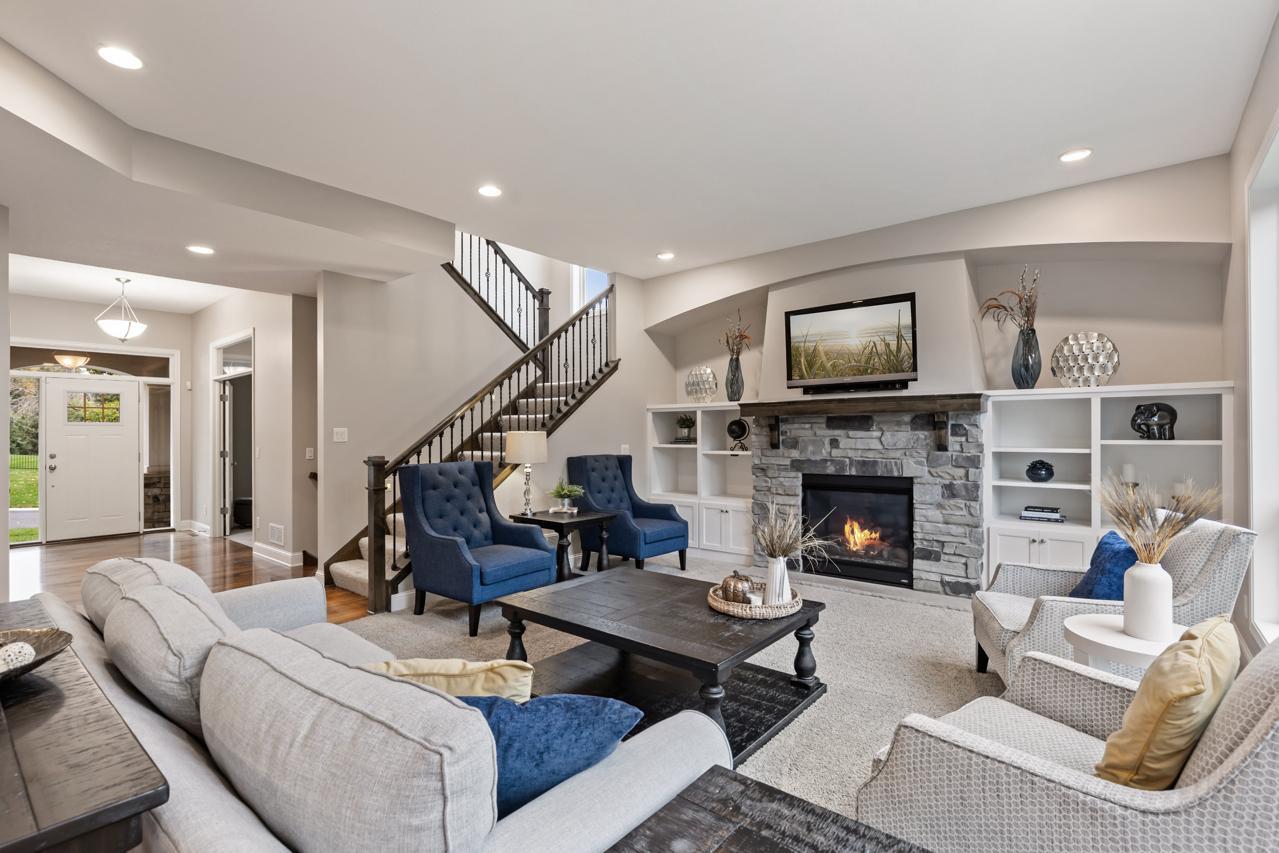 A beautiful living room centered around a gas fireplace, with custom built-ins that add style and function.