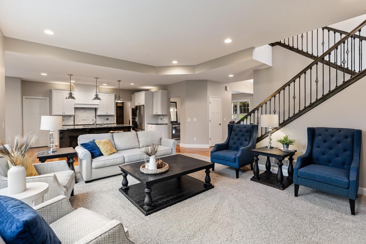 From the living room, an open view into the kitchen showcases the connected, spacious layout.