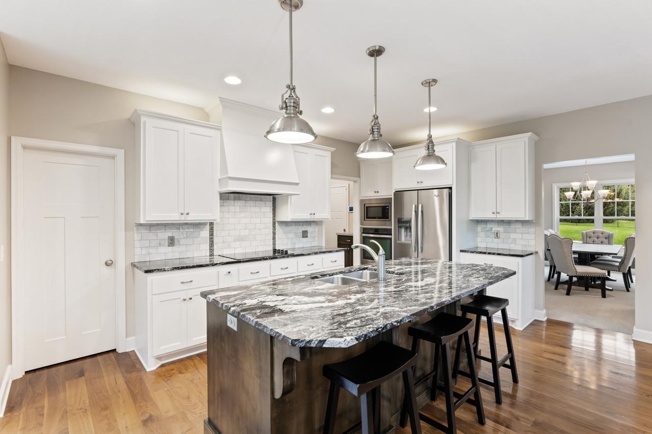 Kitchen includes a walk-in pantry and offers easy access to the formal dining room for seamless entertaining.