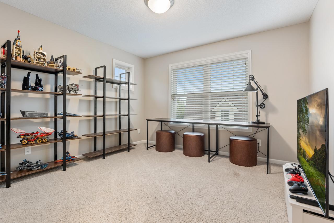 Upper-level third bedroom featuring generous space for family or guests.