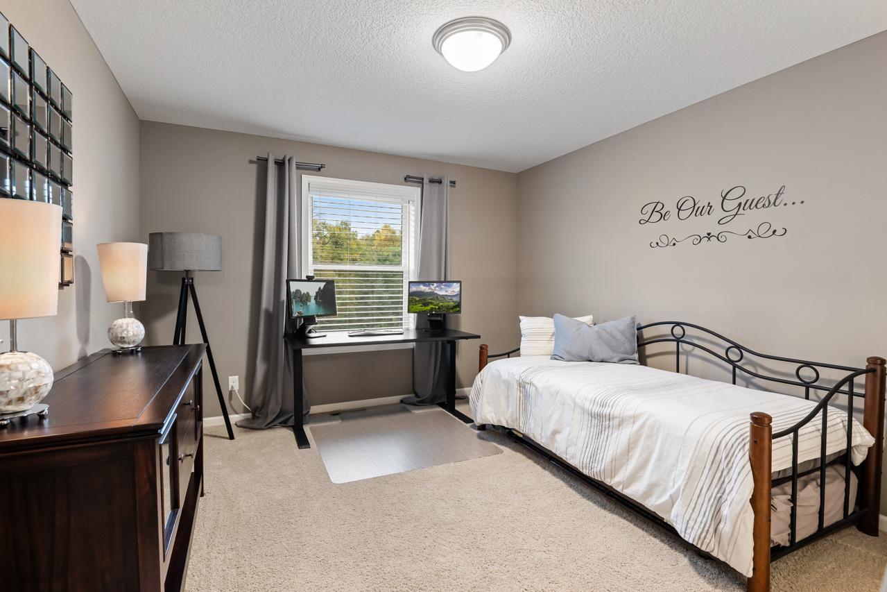 Upper-level second bedroom with generous space and a welcoming feel.