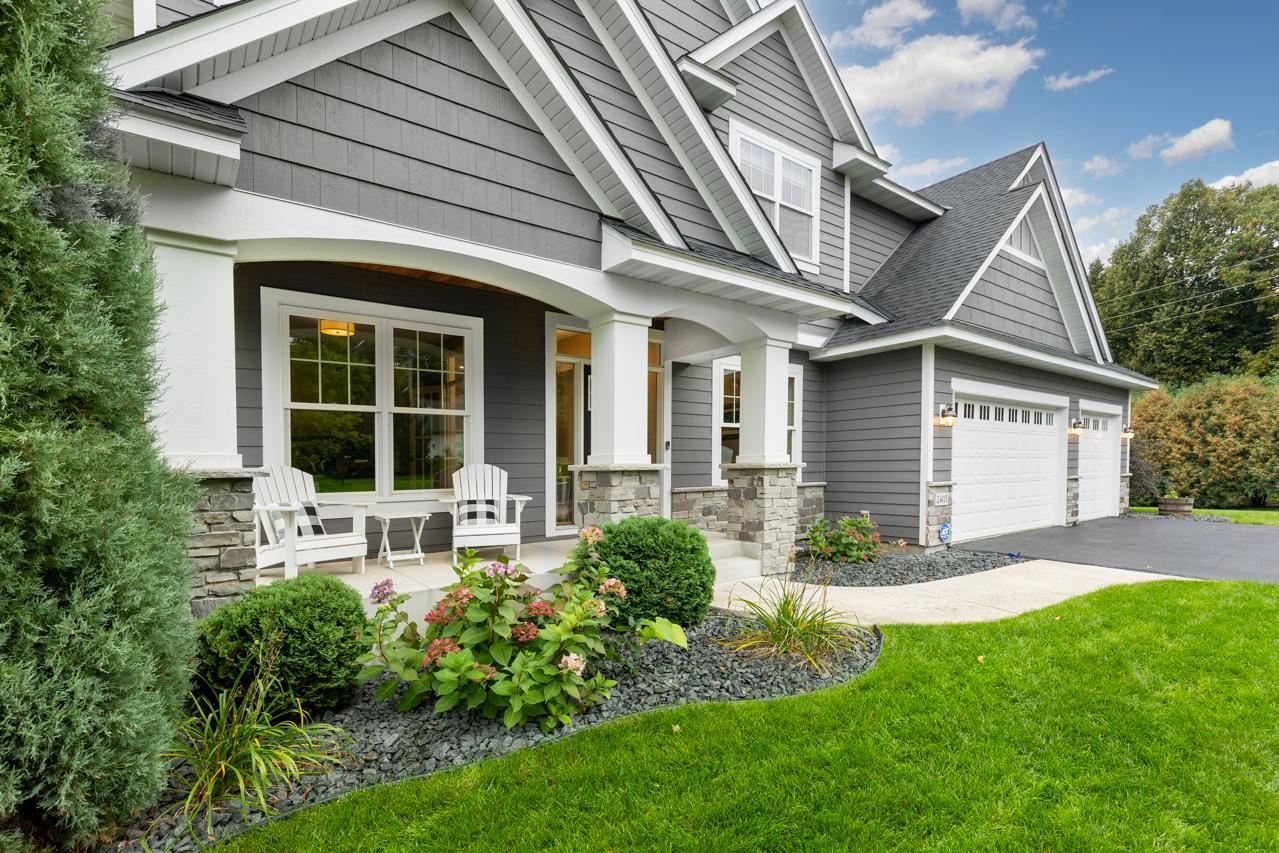 A warm, welcoming front porch complemented by thoughtfully designed, professional landscaping.