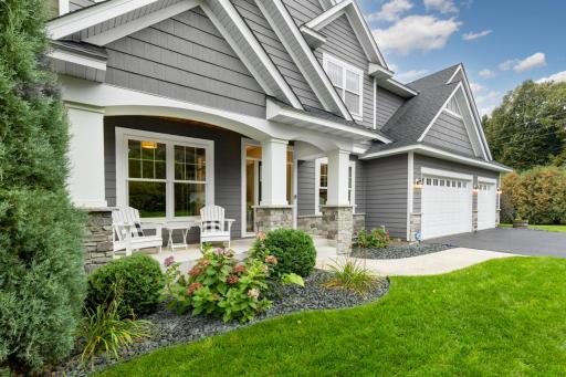 A warm, welcoming front porch complemented by thoughtfully designed, professional landscaping.