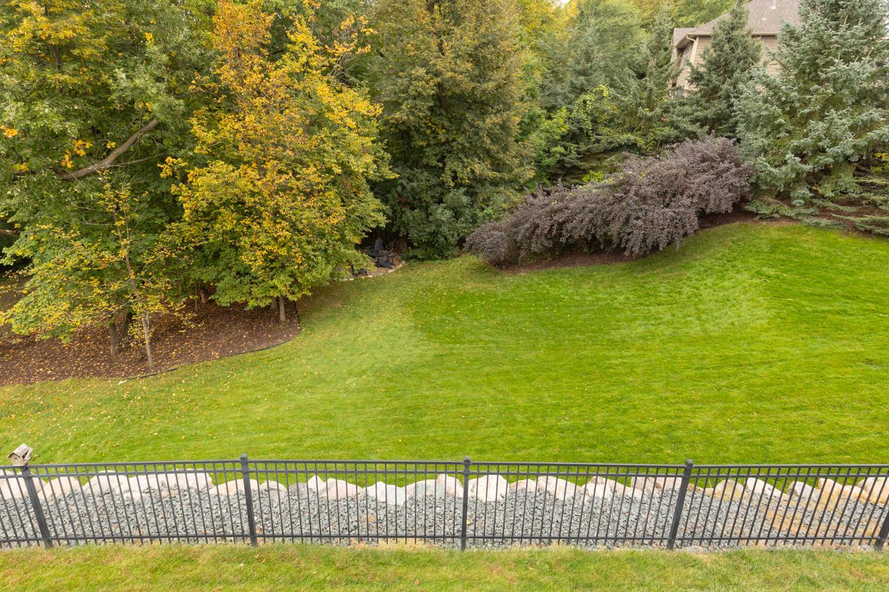 Incredible tree-lined backyard offering unmatched privacy and natural beauty.