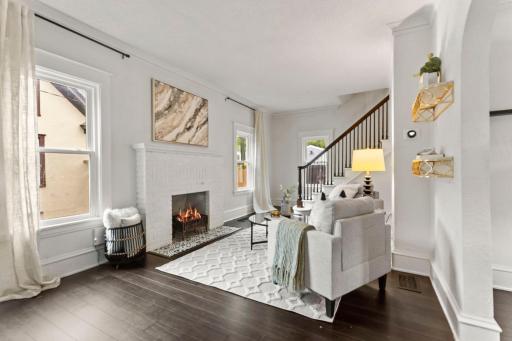 A decorative fireplace featuring a mix of tile and brick adds a fun focal point and a little extra character to the space.