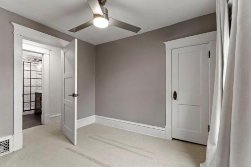 Both upper-level bedrooms feature ceiling fans, walk-in closets, and updated carpet (2021).