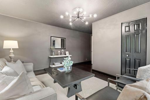 A main-level family room offers beautiful hardwood floors, dual closets, and a stacked Samsung washer and dryer.