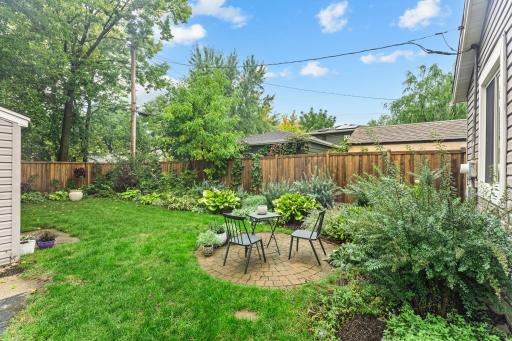 Outside, a paver patio and firepit create a natural gathering spot, while privacy fencing added in 2024 makes the outdoor space feel even more inviting.