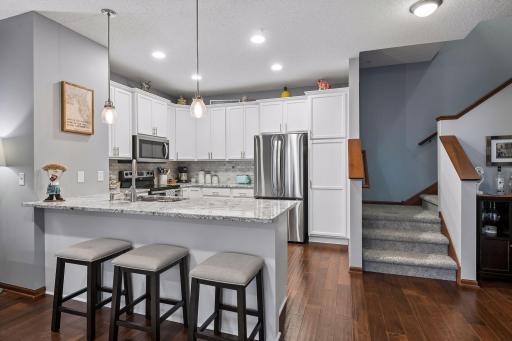 Kitchen remodel: new fridge, painted cabinets, backsplash, granite countertops, new sink