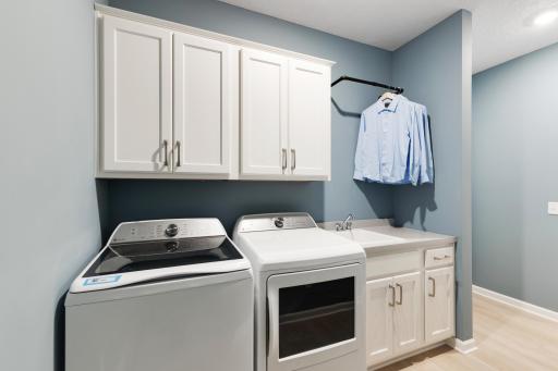 The main floor laundry has the option for a sink and cabinets. *Model home photos, many options to choose on this to be built home.*