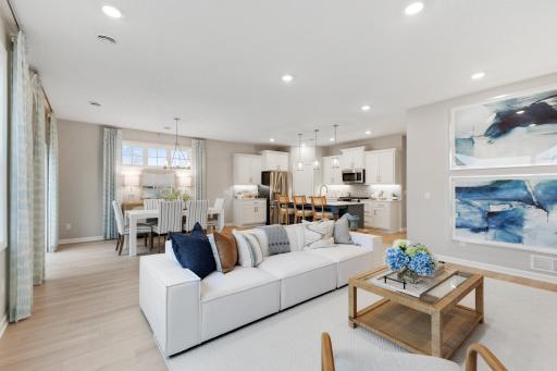 A great angle from the living room looking into the dining and kitchen areas. *Model home photos, many options to choose on this to be built home.*