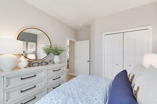 The additional bedroom on the main level is separate from the owner's suite offering privacy as well. *Model home photos, many options to choose on this to be built home.*