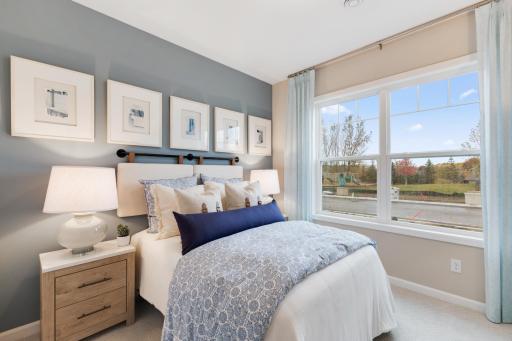 The owner's suite offers large windows, a spacious bath and large walk in closet. *Model home photos, many options to choose on this to be built home.*