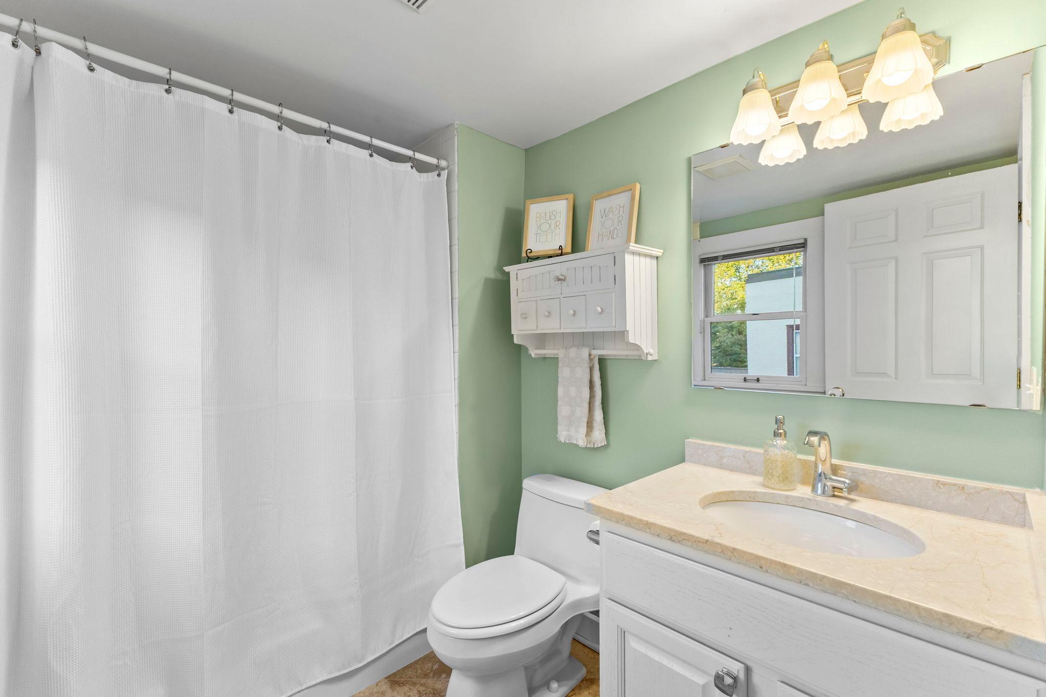 Second level full bath with ceramic floor and granite countertop