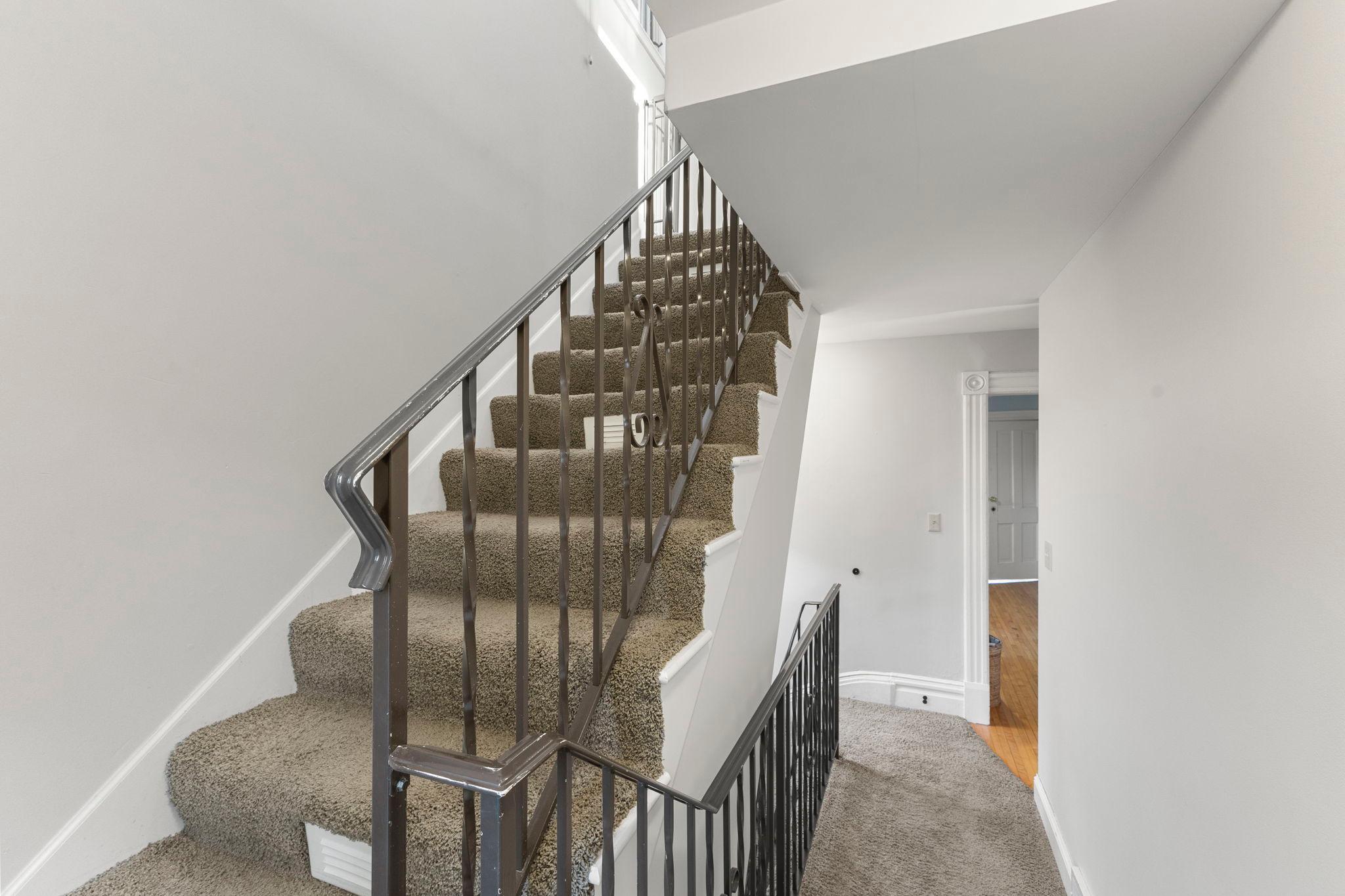 Stairway leading to third level primary suite