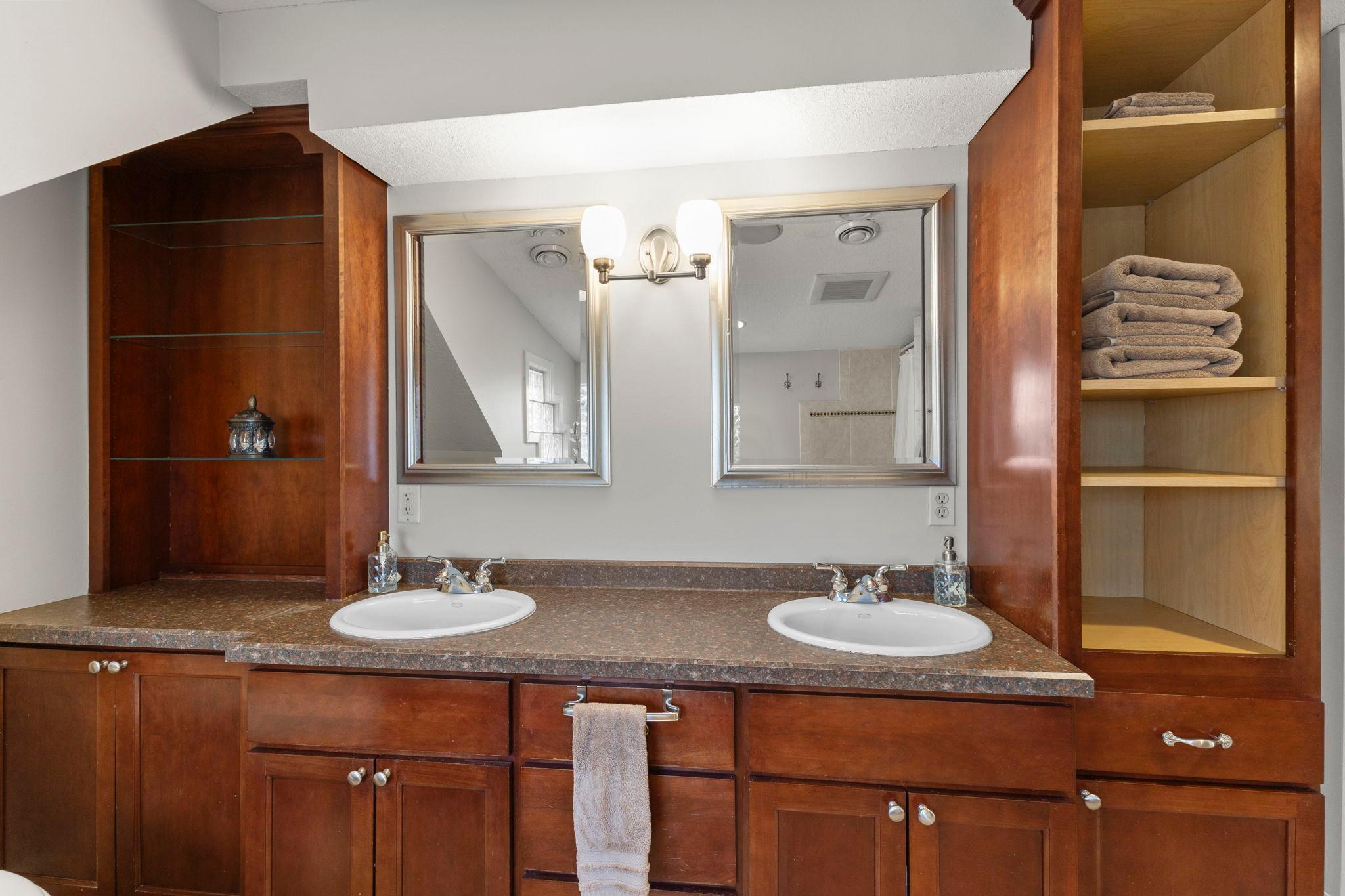 Double sinks, cherry cabinets and granite counters