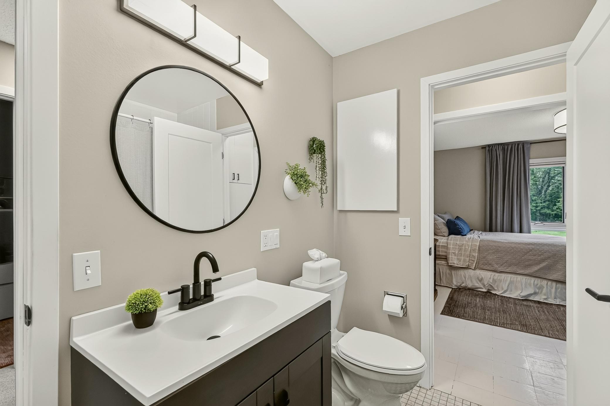Beautifully refreshed featuring a new vanity, illuminated mirror and updated lighting, with convenient direct access from the third bedroom.