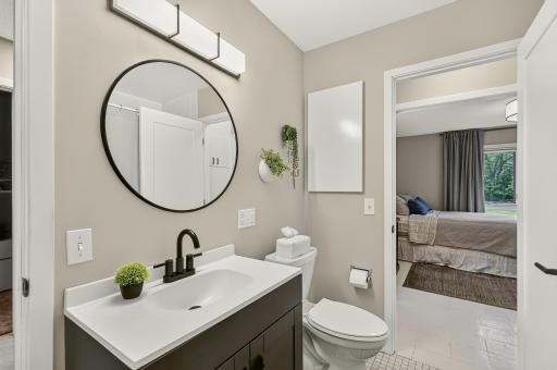 Beautifully refreshed featuring a new vanity, illuminated mirror and updated lighting, with convenient direct access from the third bedroom.