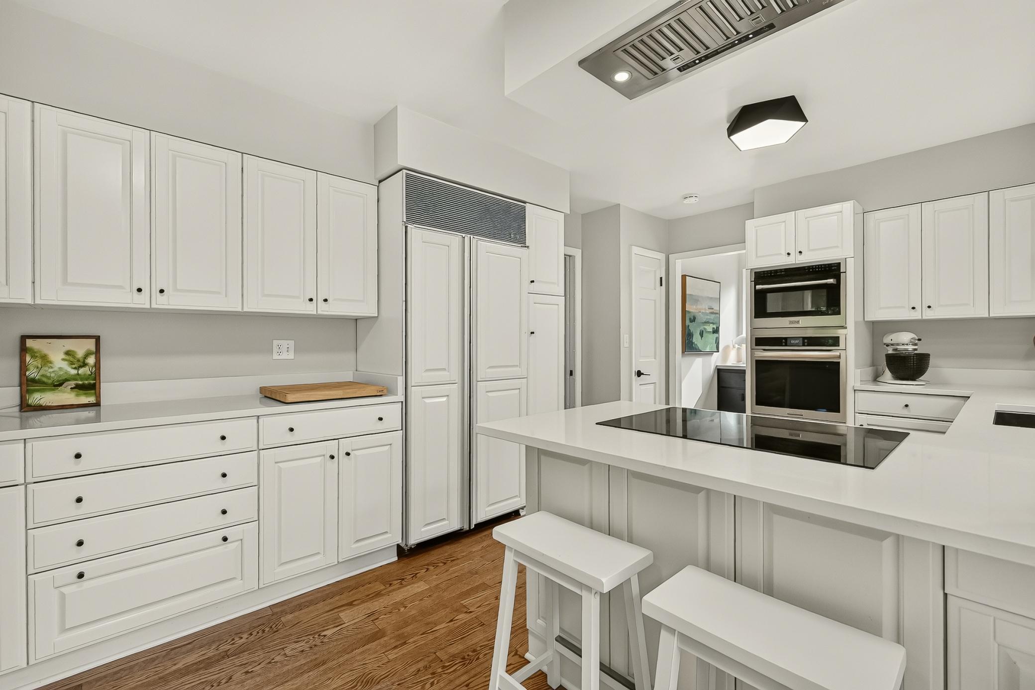 Plenty of cabinet space warmed up with the newly refinished hardwood flooring.