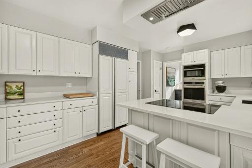 Plenty of cabinet space warmed up with the newly refinished hardwood flooring.
