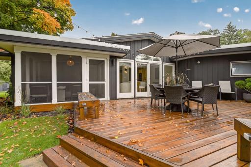 Twinkle lights surround the deck, creating a warm and inviting space to linger outdoors well into the evening, while the screened porch offers another perfect spot to relax while still taking in the outdoor air.