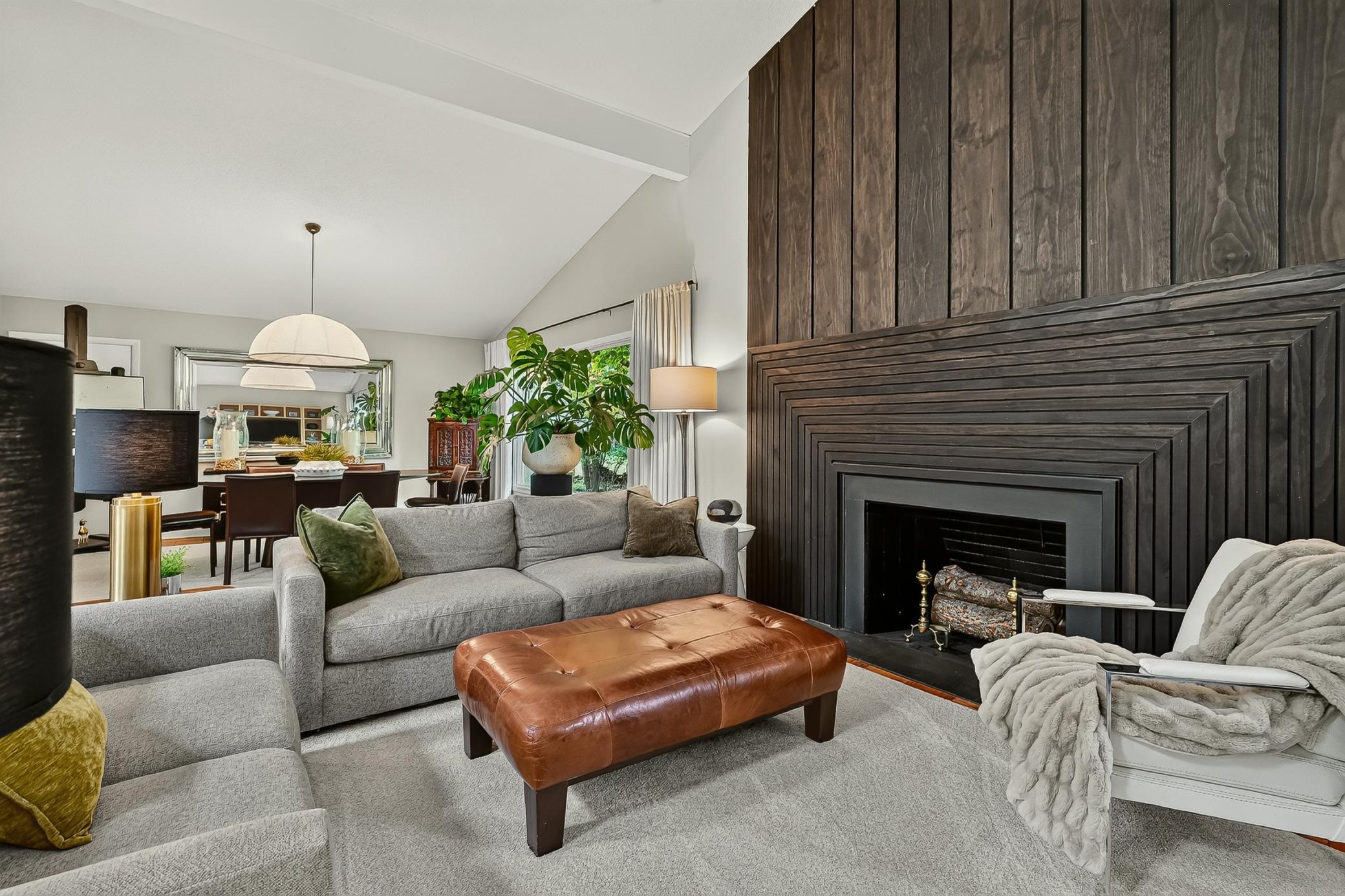 Large but cozy living room highlighted by the custom full wall fireplace surround.