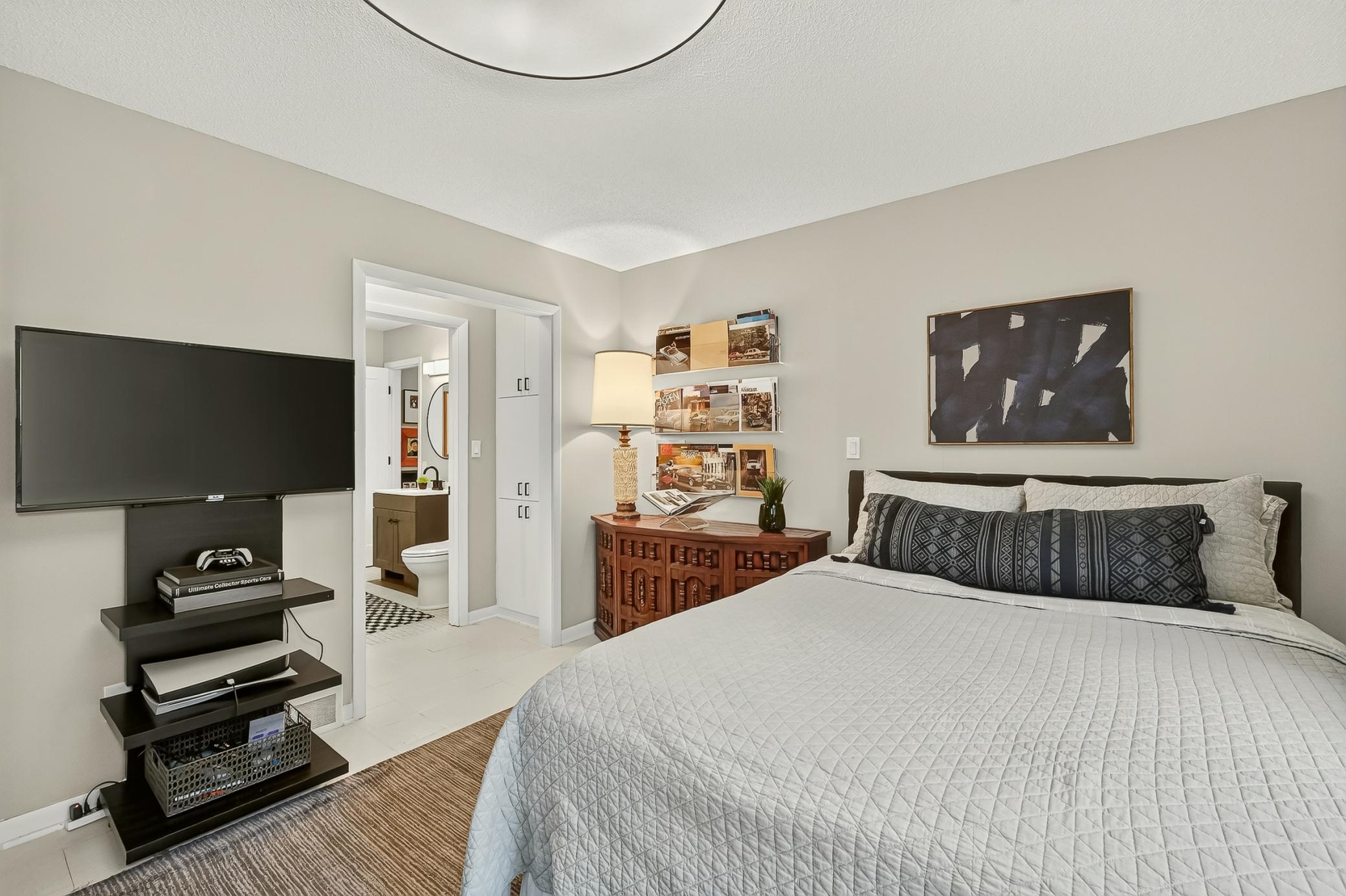 Abundant built-in storage welcomes you into the bathroom, plus a spacious walk-in closet (not pictured).