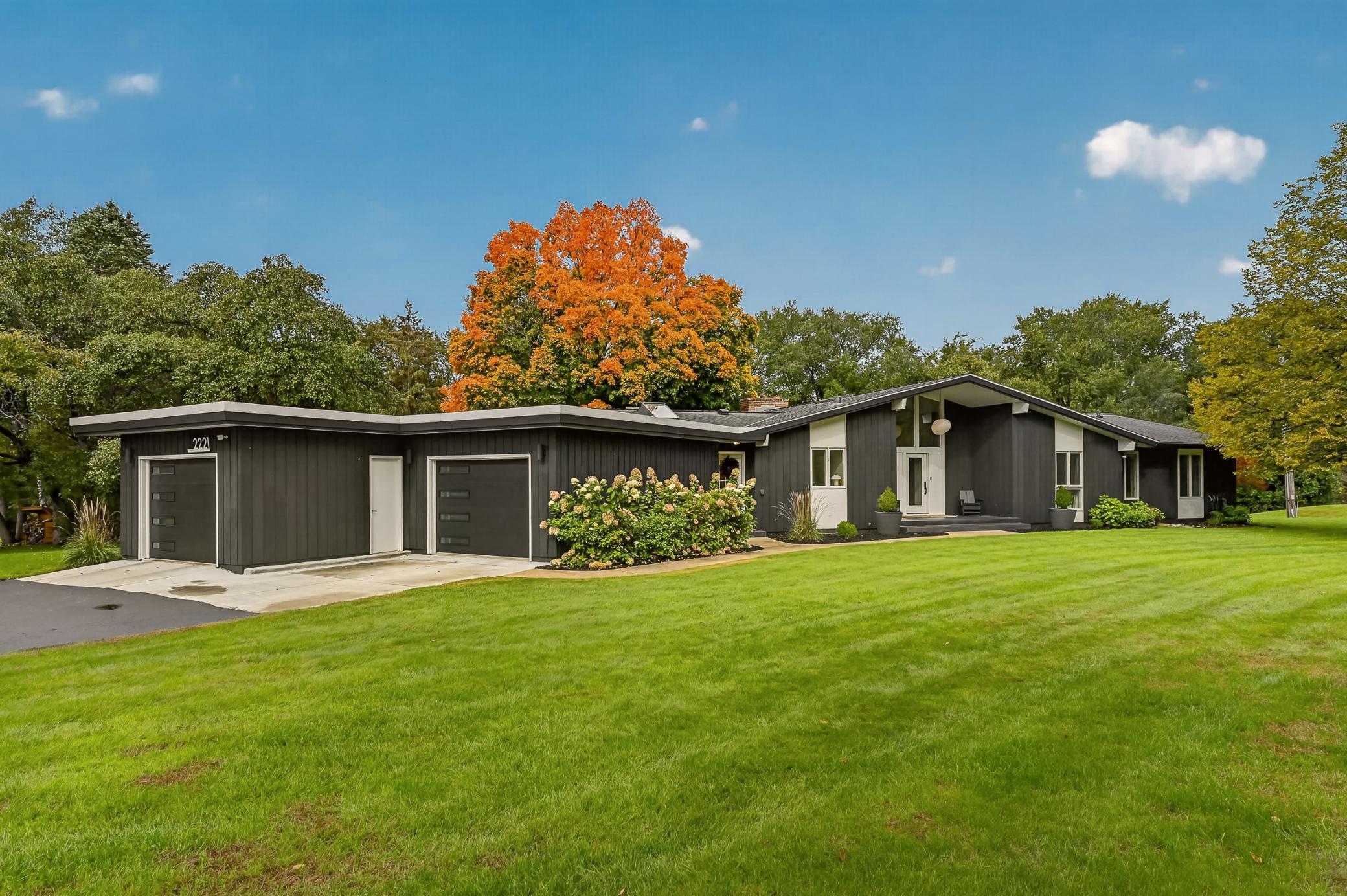 Timeless mid-century architecture, beautifully framed by mature trees and the peaceful, picturesque setting of Merrihills.