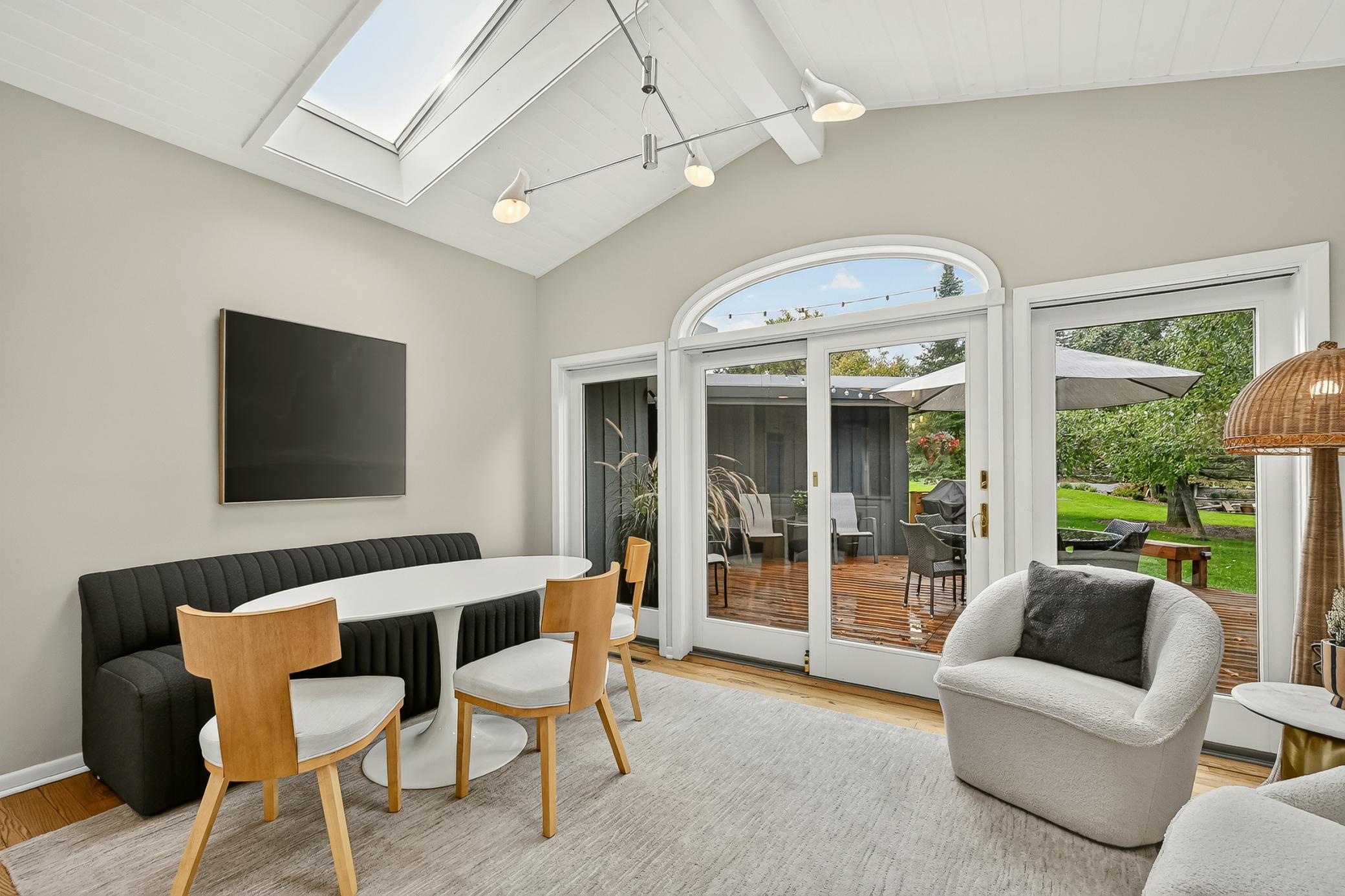 Eat in kitchen, featuring sky lit vaulted ceilings and a dramatic wall of windows leading out to the oversized deck.
