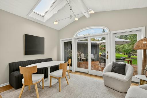 Eat in kitchen, featuring sky lit vaulted ceilings and a dramatic wall of windows leading out to the oversized deck.