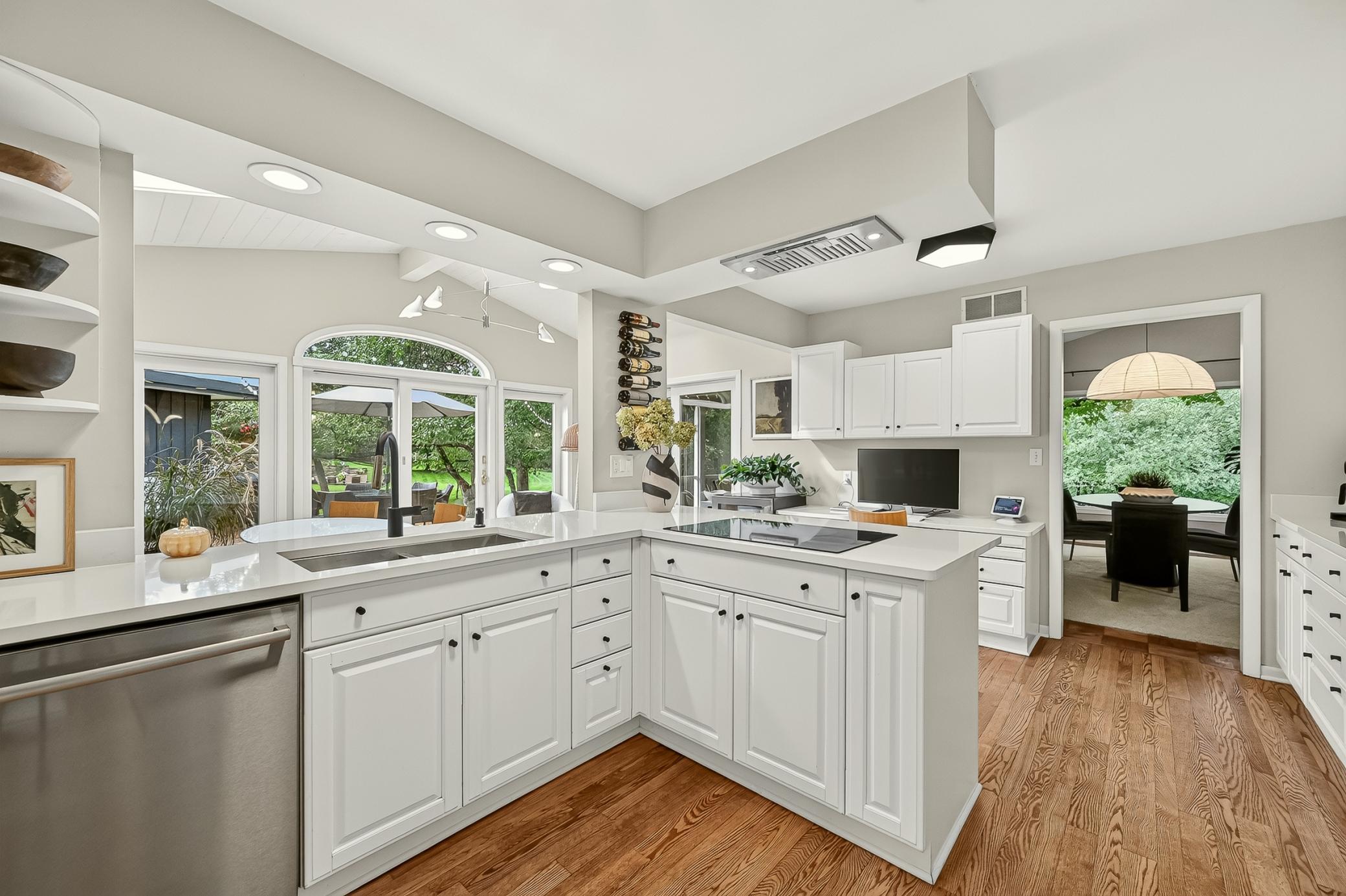 Bathed in natural light, the spacious kitchen features new quartz countertops, gorgeous hardwood floors, all new lighting and an induction cooktop.