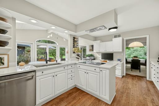 Bathed in natural light, the spacious kitchen features new quartz countertops, gorgeous hardwood floors, all new lighting and an induction cooktop.