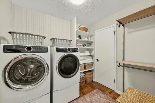 Second bedroom walk in closet doubles as the main floor laundry room (right outside of primary ensuite). There is also a wall of closets in hallway for over flow.