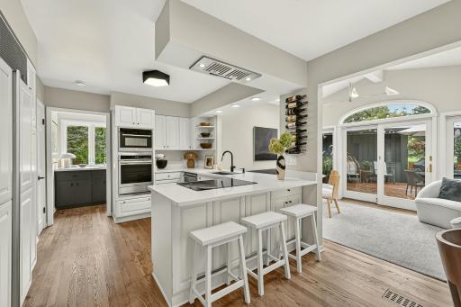 Breakfast bar and expansive eat-in kitchen with the feel of a sunroom.