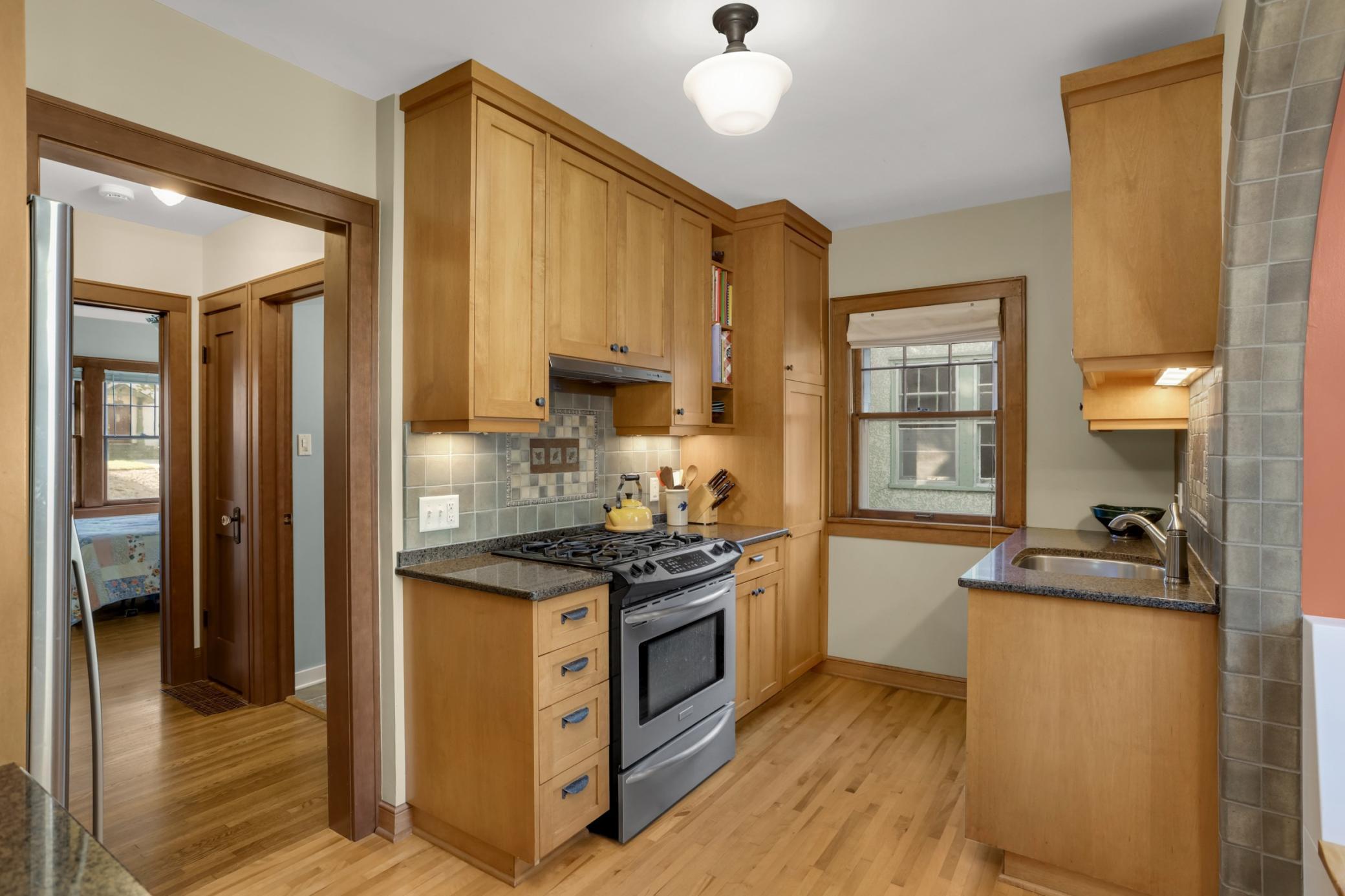 The beautifully updated kitchen is a true highlight of this gorgeous home, including custom cabinetry and stainless appliances