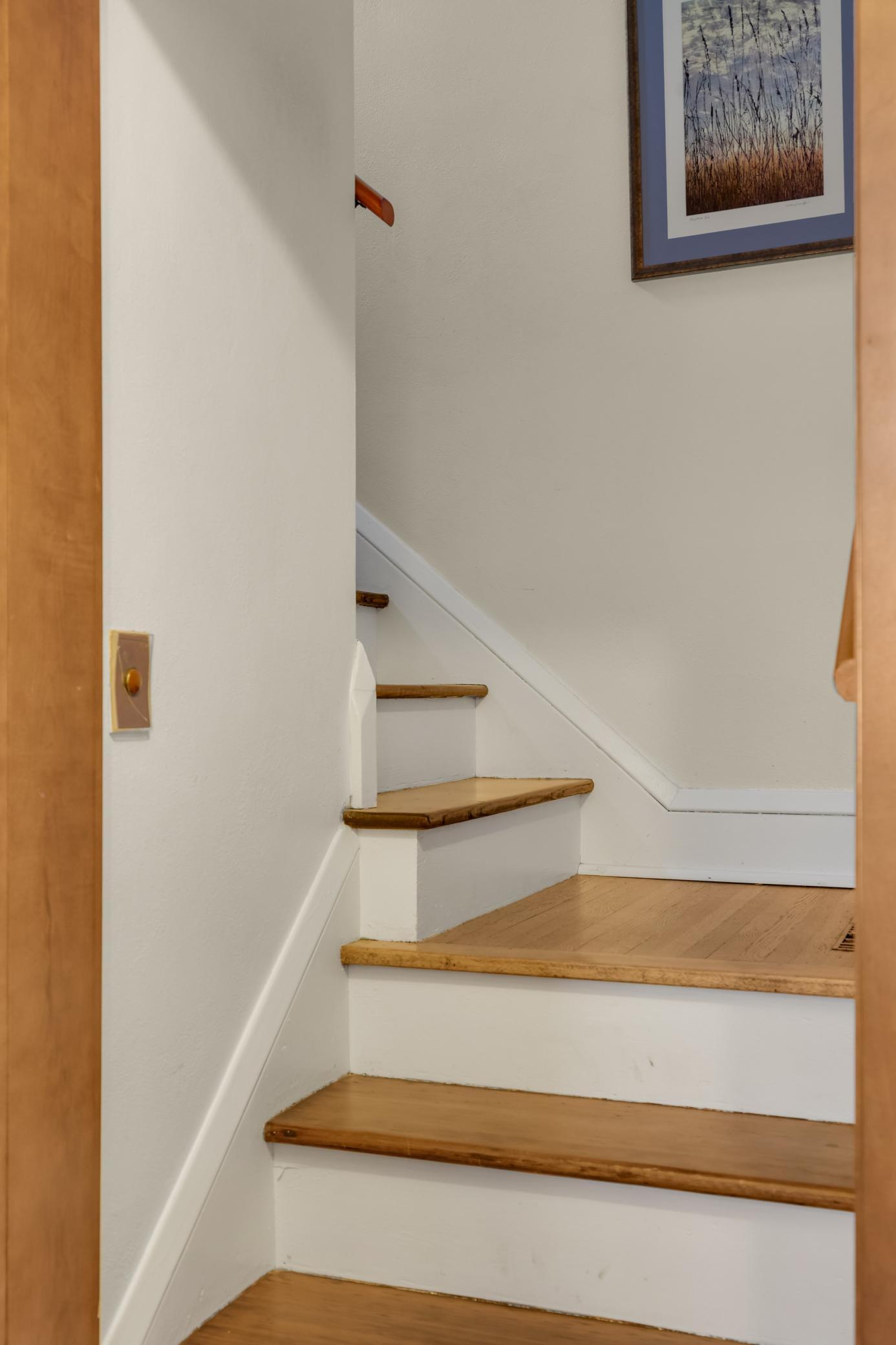 The beautifully detailed staircase leads up to the upper level