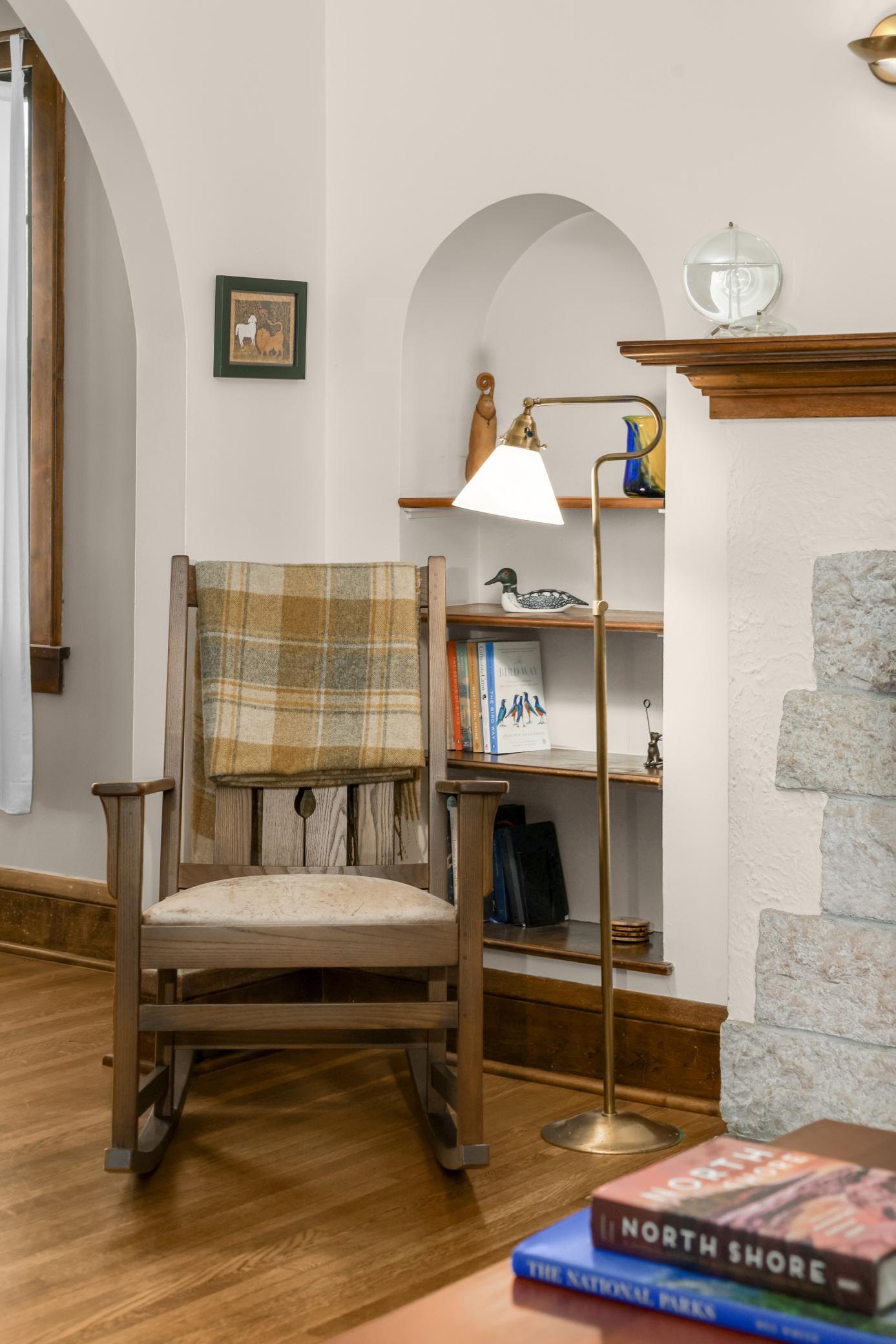 The arched built-in bookshelves frame the fireplace and add interesting detail to the space