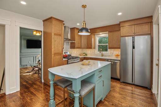 All new down to the studs renovated kitchen featuring quartz countertops, center island and under cabinet lighting.
