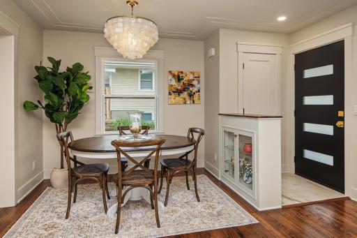 Classic yet elevated midcentury entry with walnut topped shelving in dining room.