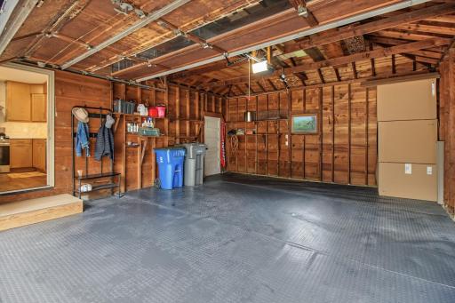 Two car attached garage with mat flooring.
