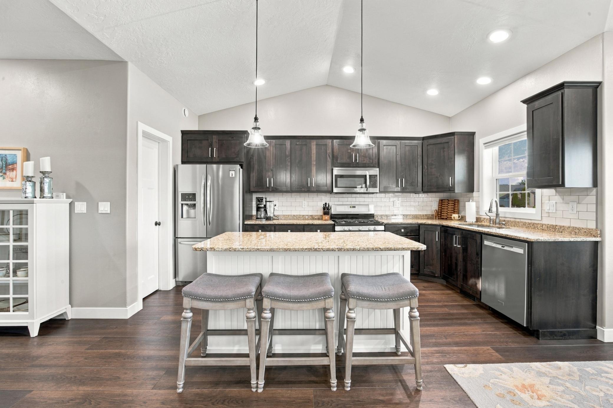 Kitchen featuring granite countertops, gas range and walk-in pantry