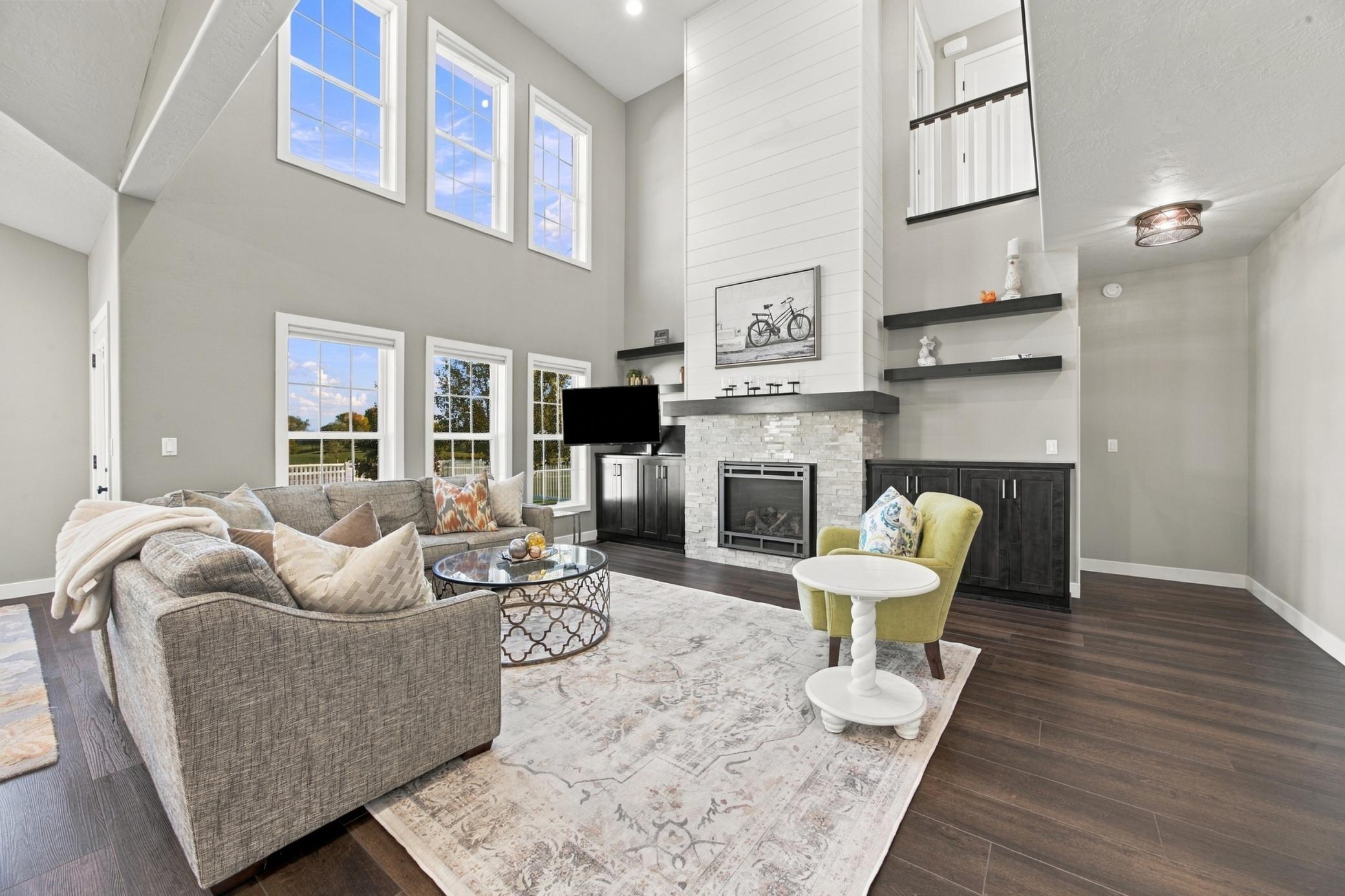 Living Room featuring built-in cabinets and custom tv mount with motor that lowers into cabinet.