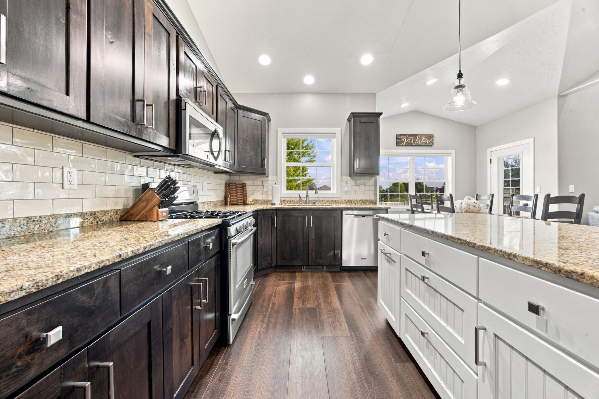 Kitchen featuring granite countertops, gas range and walk-in pantry