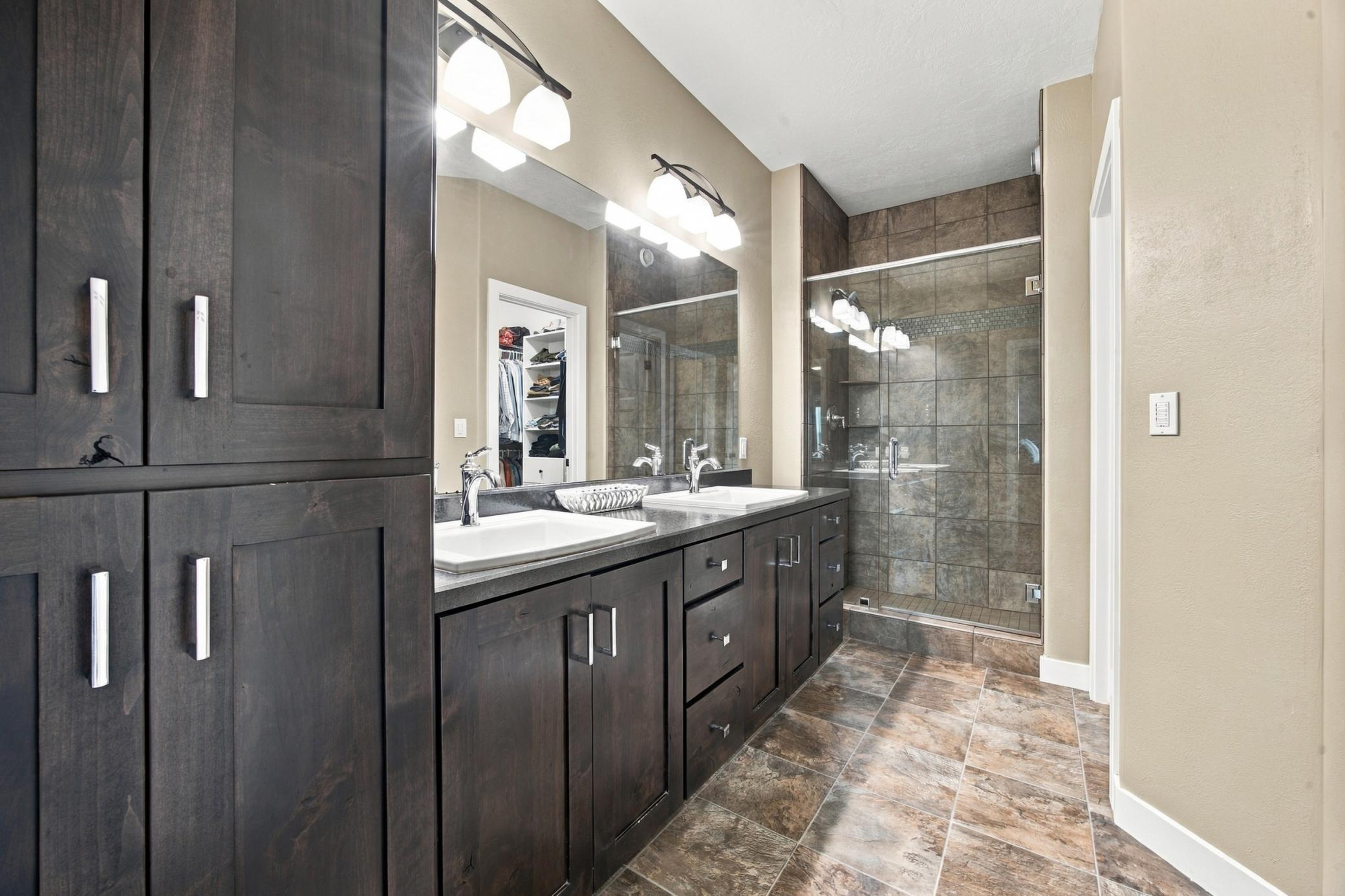 Primary Bathroom with double sinks tiled shower and separate water closet.
