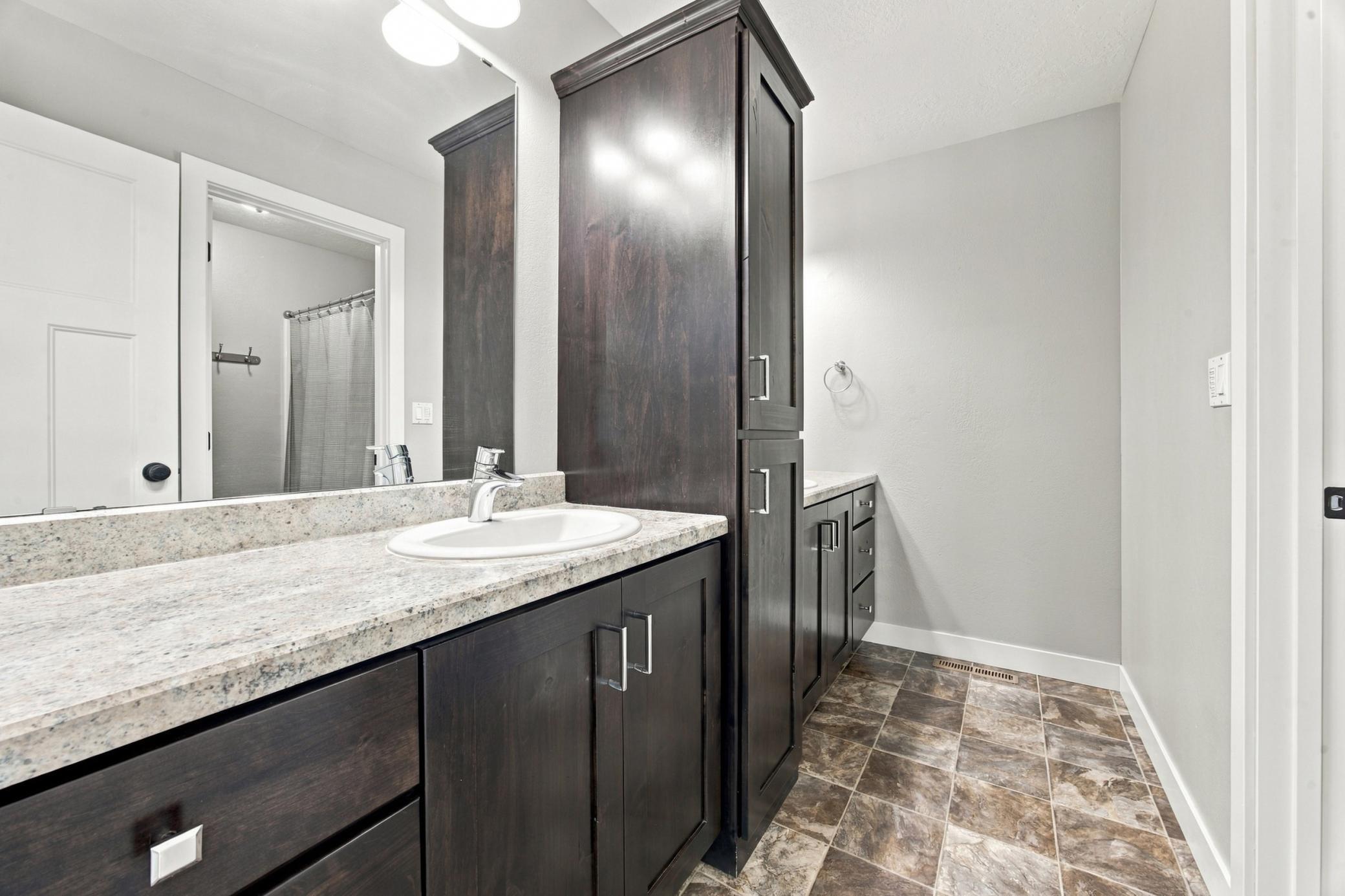 Upstairs full bathroom with double sinks and separate tub/shower and lavatory