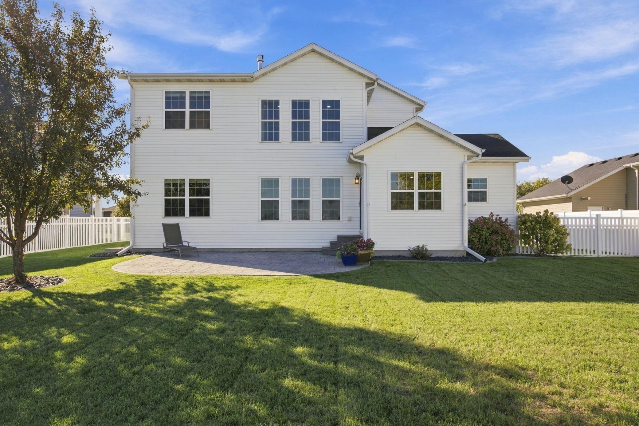 Rear of home with large stamped concrete patio