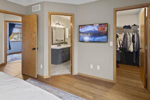 The primary bedroom overlooks the rear yard, features a walk-in closet, and provides direct access to the upstairs full bathroom.
