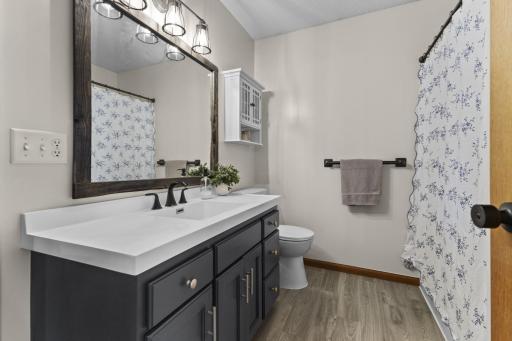 The upstairs full bathroom provides a tub/shower combination, and updated cabinetry, mirror, lighting and ceramic tile plank flooring plus fresh paint!